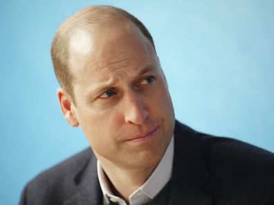Prince William listens to staff during a visit to the Open Door Charity, 2023. 