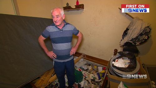 Mr Smith stands in his trashed home. (9NEWS)