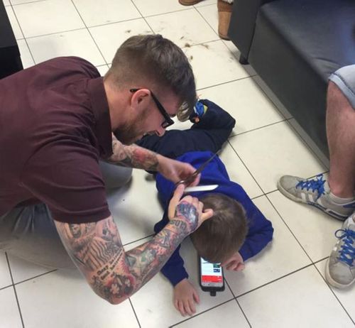 Barber goes to extreme lengths to make boy with autism comfortable during haircut