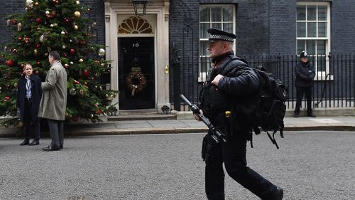 Armed police guide 10 Downing Street. (AAP)