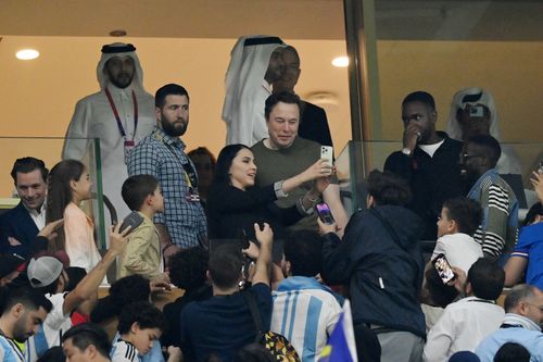 Fans take photos with Elon Musk during the FIFA World Cup Qatar 2022 Final match between Argentina and France at Lusail Stadium.