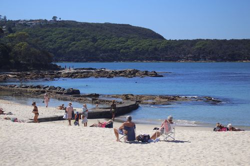 Sydneysiders enjoy the warm weather at Balmoral Beach at midday. (Picture: Cade Thompson)