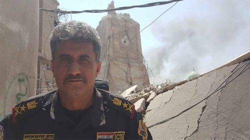 ISOF General Abdul Wahab al-Saadi outside the ruins of the leaning minaret of al-Nuri mosque. (Owen Holdaway)