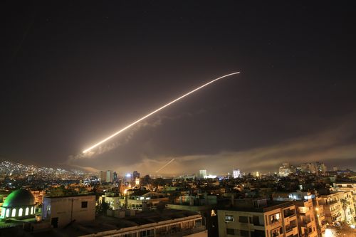 Damascus sky lights up with service to air missile fire as the US launches an attack on Syria. (AAP)