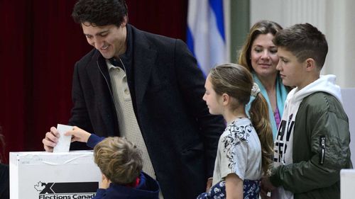 Justin Trudeau casts his ballot surrounded by family members this morning.