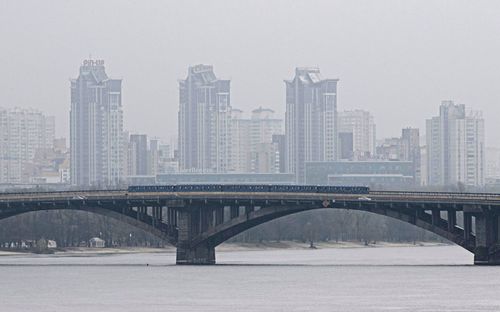 Metro train runs on the bridge over Dnipro river in Kyiv, Ukraine, Friday, November 11, 2022.