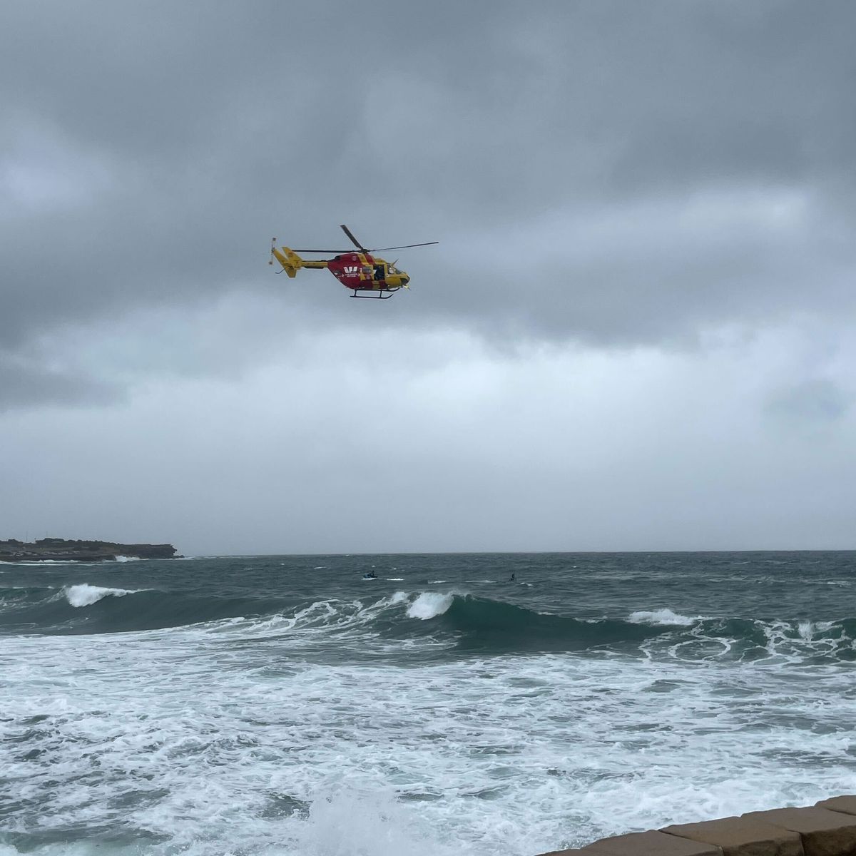 Urgent search for missing swimmer hours after body found at Sydney beach