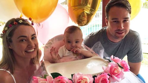 Billie Ava Stevens celebrating her first birthday with her parents. (Supplied)