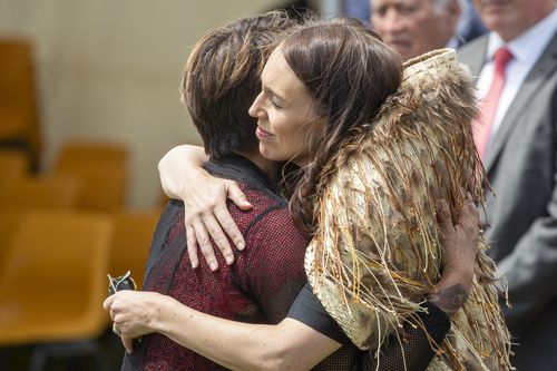 New Zealand Prime Minister Jacinda Ardern, right, is hugged as she and her caucus are welcomed to Ratana, New Zealand, Tuesday, Jan. 24, 2023. 
