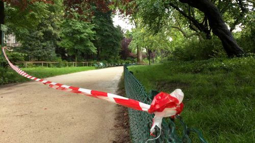 White-and-red tape is strung across a sandy pathway through Park Monceau after a lightning stike. (AP)