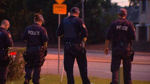 Officers go over the scene where a 22-year-old woman was shot in Hoxton West outside Sydney. (9NEWS)