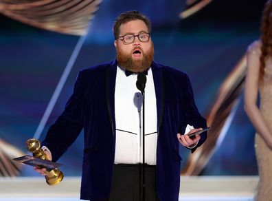 Paul Walter Hauser accepts the Best Performance in a Limited or Anthology Series or Television Film award for "Black Bird" onstage at the 80th Annual Golden Globe Awards 