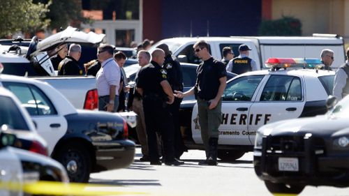 Police officers gather at the site where a Sacramento County Sheriff's deputy was shot. (AAP)