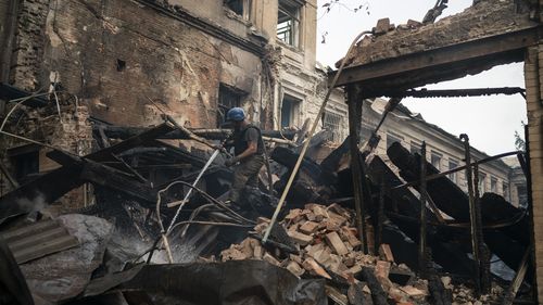 A firefighter works to extinguish a fire after a Russian attack damaged a building of a technical school in Slovyansk, Ukraine, Friday, Aug. 26, 2022. (AP Photo/Leo Correa)