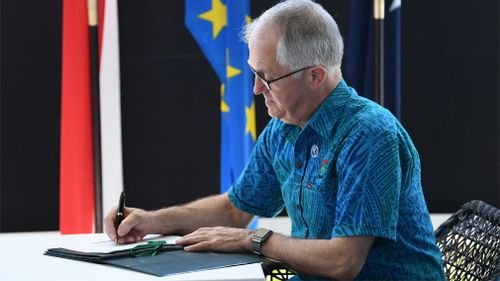 Malcolm Turnbull igns a Memorandum of Understanding during the 48th Pacific Islands Forum at the Taumeasina Resort in Apia. (Image: AAP)