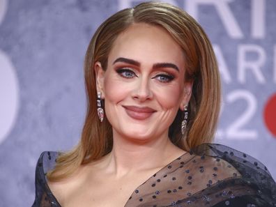 Adele poses for photographers upon arrival at the Brit Awards 2022 in London Tuesday, Feb. 8, 2022. 