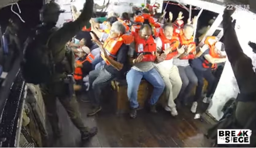 A still from a YouTube livestream shows armed Israeli personnel intercepting the Handala aid ship en route to Gaza.