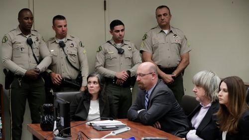 Defendants Louise Anna Turpin, left, with attorney Jeff Moore, and David Allen Turpin, right, with attorney Allison Lowe, appear in court for their arraignment in Riverside, California on January 18. (AAP)