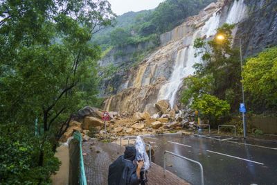 Rocks and soil from a landslide block a road during heavy rain in Hong Kong, China, on Sept. 8, 2023. Hong Kongs heaviest rainstorm since records began in 1884 flooded the financial hubs streets and sent torrents of water rushing through subway stations, bringing much of the city to a standstill and forcing the stock market to halt morning trading on Friday. Photographer: Justin Chin/Bloomberg