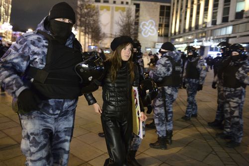 Police detain a demonstrator during an action against Russia's attack on Ukraine in Moscow, Russia, Saturday, Feb. 26, 2022. Protests against the Russian invasion of Ukraine resumed on Saturday evening, with people taking to the streets of Moscow and St. Petersburg for the third straight day despite mass arrests. OVD-Info rights group reported that at least 325 people were detained in 26 Russian cities on Saturday in antiwar protests, nearly half of them in Moscow. (AP Photo/Denis Kaminev)