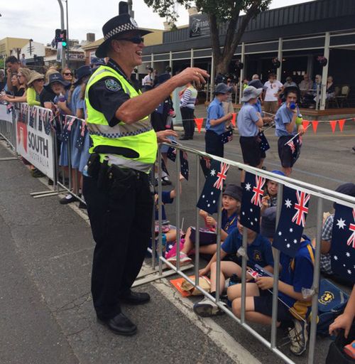 A South Australia policeman laughing at school kids trying to bribe him with a jam sandwich. (SA Police)