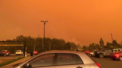 A photo red skies above the carpark at the Port Macquarie highway McDonalds when the bushfire threat emerged on November 8. 