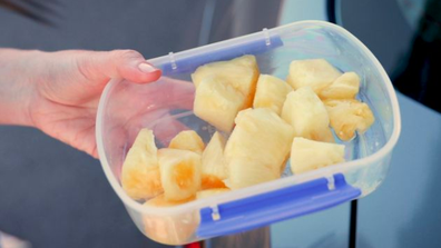 Fresh pineapple pieces in a container