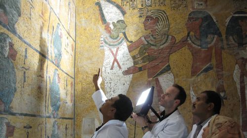 Undertaking a visual examination of the wall painting in the burial chamber in February 2009. Scientists compared photographs taken in the 1920s with the current condition of the paintings, showing there was no change in the spots. Picture: Courtesy of J Paul Getty Trust
