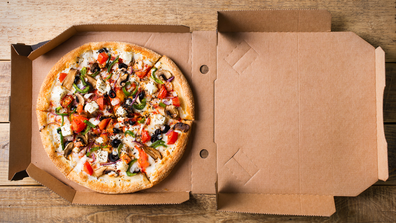 Stock image of pizza in a takeaway box