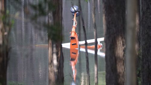 The wheel of the aircraft emerging from the dam it crashed into.