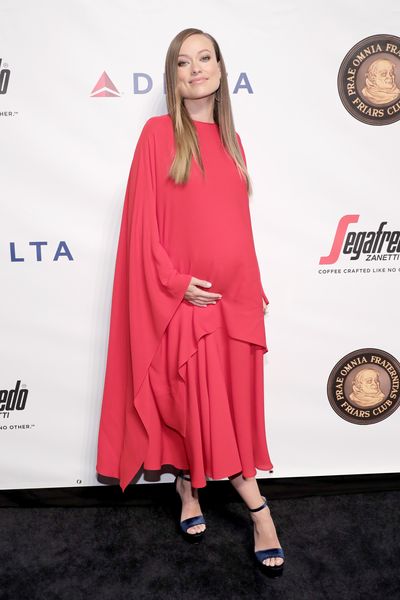 Olivia Wilde drapes her baby belly in red.