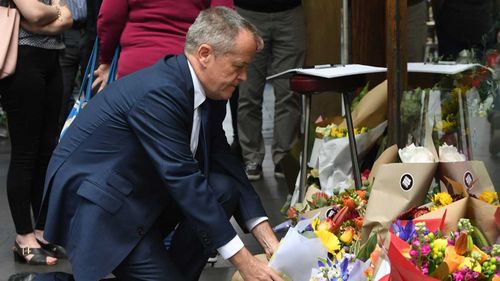 Opposition Leader Bill Shorten leaves flowers at a makeshift memorial for Sisto Malaspina.