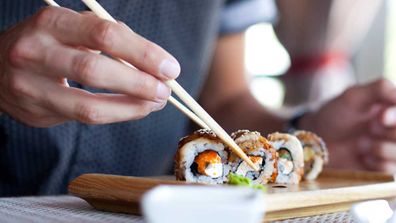 Man eats sushi