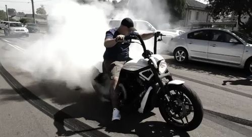 A motorbike rider wearing no helmet is also filmed filling the neighbourhood with smoke.