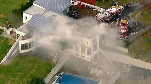 A man has been arrested after his brother's family were found killed and their New Jersey mansion set ablaze.