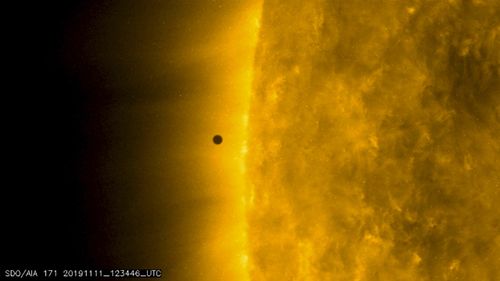 This still image from video issued by NASA's Solar Dynamics Observatory shows Mercury as it passes between Earth and the sun on Monday, November 11, 2019. The solar system's smallest, innermost planet resembles a tiny black dot during the transit.