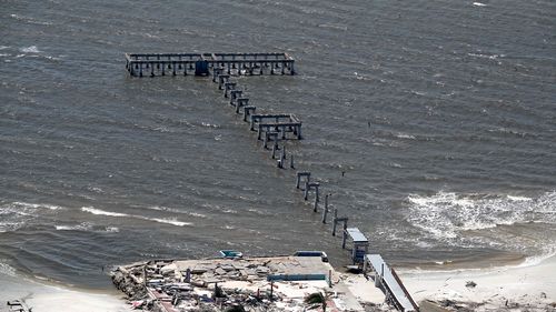 This aerial photo shows the damaged Fort Myers Fishing Pier in the aftermath of Hurricane Ian on Thursday, Sept. 29, 2022 in  Fort Myers Beach, Fla.  (Joe Cavaretta/South Florida Sun-Sentinel via AP)