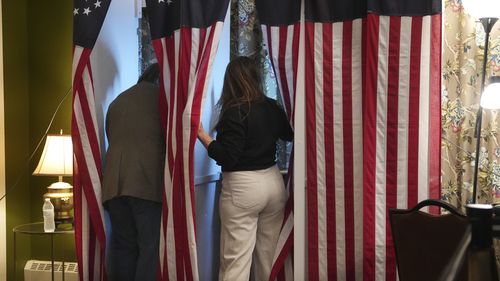 Voters cast their ballots during the midnight vote in the presidential election, Tuesday, Nov. 5, 2024, in Dixville Notch, N.H.