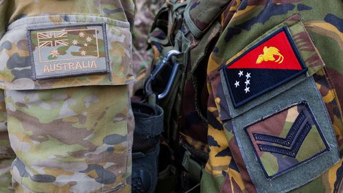 The emblem of an Australian Army soldier, left, and a Papua New Guinea Defence Force soldier during an exercise at Talisman Sabre in Townsville, Australia, on July 21, 2025.