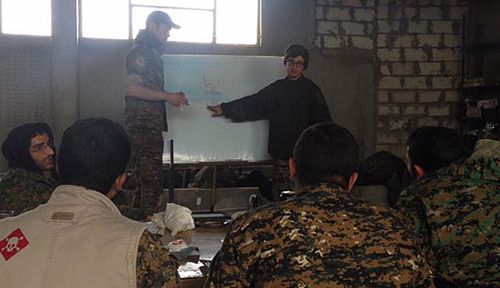 Lucas Chapman and his YPG comrades talk tactics. (Photo: Lucas Chapman).