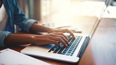 woman typing on laptop. 