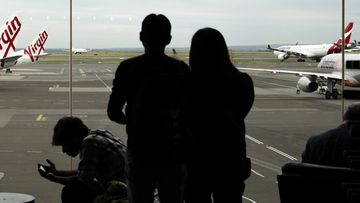 Passengers wait to catch their flights at Sydney&#x27;s domestic airport