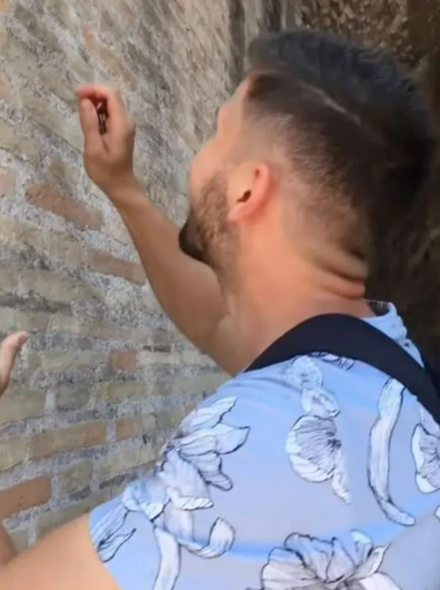 Tourist filmed carving names into Rome's Colosseum wall facing fine and prison time