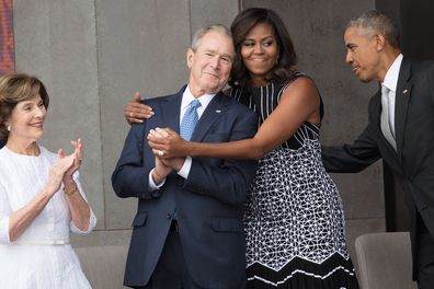 First Lady Michelle Obama hugs former President George W Bush at the opening of the National Museum of African American History and Culture, Washington DC, September 24, 2016. 