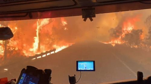 Firefighters trapped in a tunnel of fire during NSW bushfires. The crew escaped unharmed.