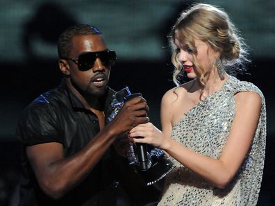 Kanye West jumps onstage as Taylor Swift accepts her award for the "Best Female Video" award during the 2009 MTV Video Music Awards at Radio City Music Hall on September 13, 2009 in New York City. 