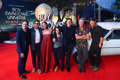 (L-R) Trent Dalton, Simon Baker, Phoebe Tonkin, Felix Cameron, Lee Tiger Halley, Bryan Brown and Travis Fimmel pose for a photograph during the Netflix global premiere of "Boy Swallows Universe" at New Farm Cinemas on January 09, 2024 in Brisbane 