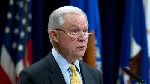 Attorney General Jeff Sessions listens to the national anthem during the opening ceremony of the summit on Efforts to Combat Human Trafficking. (AAP)