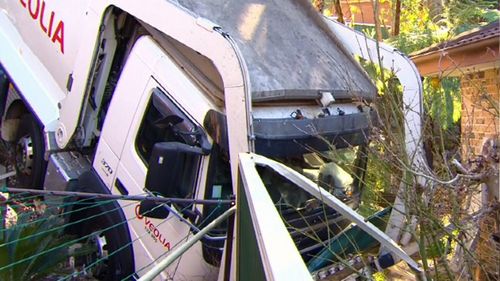 A garbage truck has smashed through a garden in Belrose, Sydney.