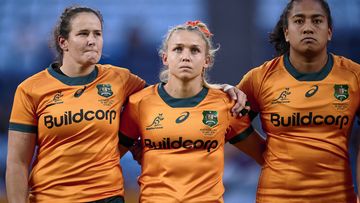  Shannon Parry, Georgina Friedrichs and Adiana Talakai of the Wallaroos stand for the anthems during the Women&#x27;s International match between the Australia Wallaroos and Fijiana at Allianz Stadium on May 20, 2023 in Sydney, Australia. (Photo by Brett Hemmings/Getty Images)